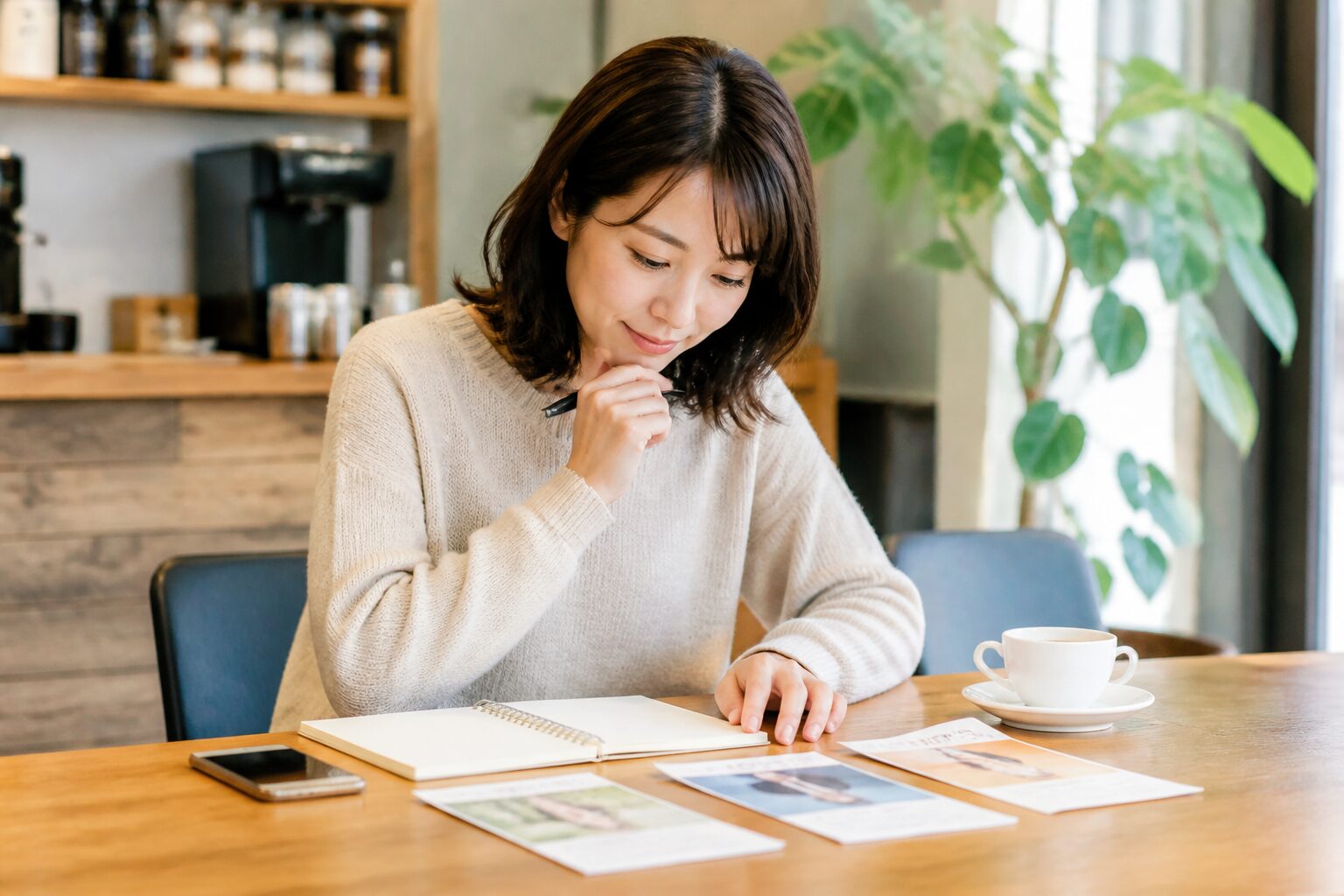 カフェで複数の婚活方法を比較する30代女性